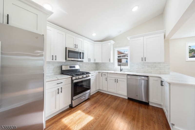 2429 Vauxhall Road Union, NJ 07083 - Photo 1 of 24 a kitchen with granite countertop cabinets stainless steel appliances and a wooden floor