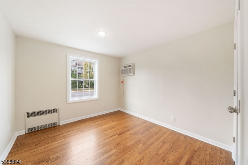 2429 Vauxhall Road Union, NJ 07083 - Photo 15 of 24 an empty room with wooden floor and windows