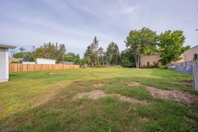 a view of a field of grass and trees
