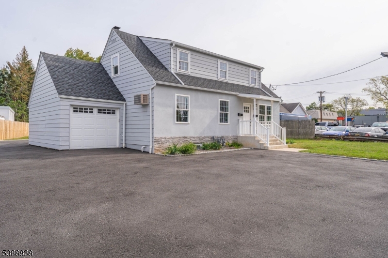2429 Vauxhall Road Union, NJ 07083 - Photo 4 of 24 a front view of a house with a yard and garage