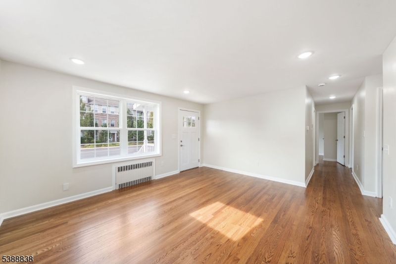 2429 Vauxhall Road Union, NJ 07083 - Photo 7 of 24 a view of an empty room with wooden floor and a window