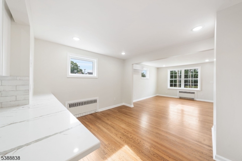 2429 Vauxhall Road Union, NJ 07083 - Photo 8 of 24 a view of a bedroom with wooden floor and windows