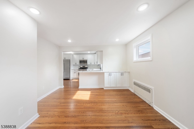 2429 Vauxhall Road Union, NJ 07083 - Photo 9 of 24 a view of kitchen with white cabinets and wooden floor