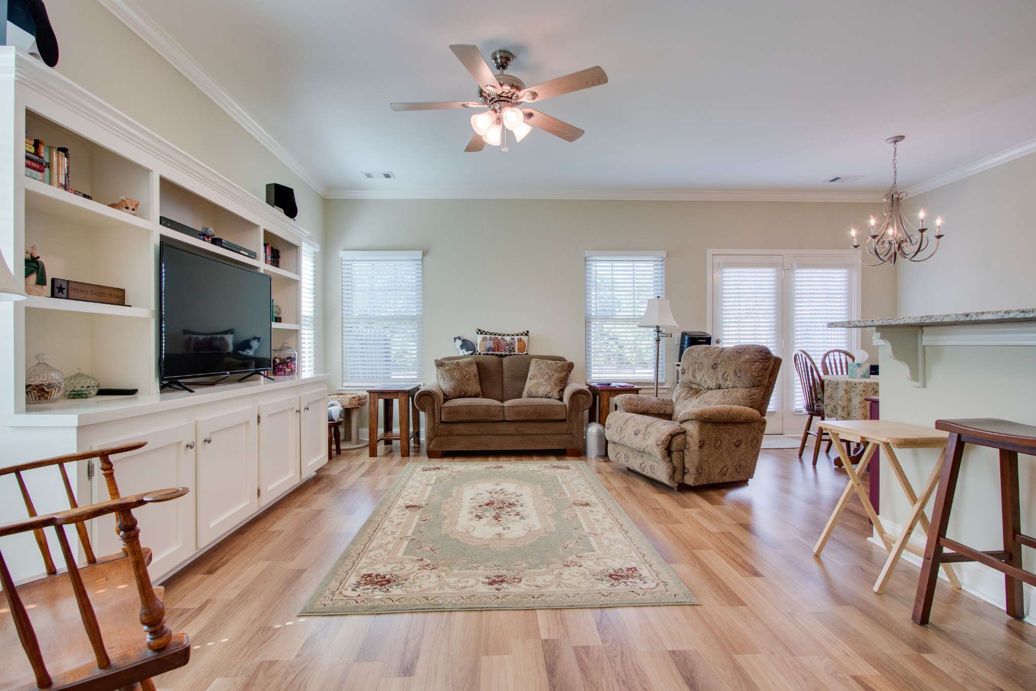 735 Tulip Grove Road, Unit 211 Hermitage, TN 37076 - Photo 3 of 26 a living room with furniture a flat screen tv and kitchen view