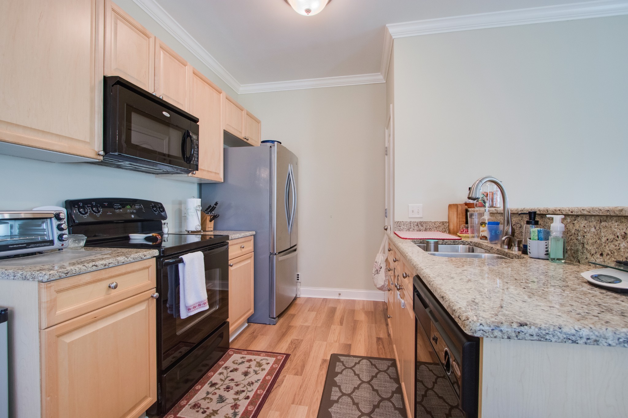 735 Tulip Grove Road, Unit 211 Hermitage, TN 37076 - Photo 10 of 26 a kitchen with stainless steel appliances granite countertop a sink stove and refrigerator