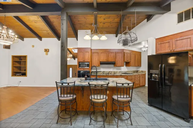 a kitchen with stainless steel appliances granite countertop a stove and a sink