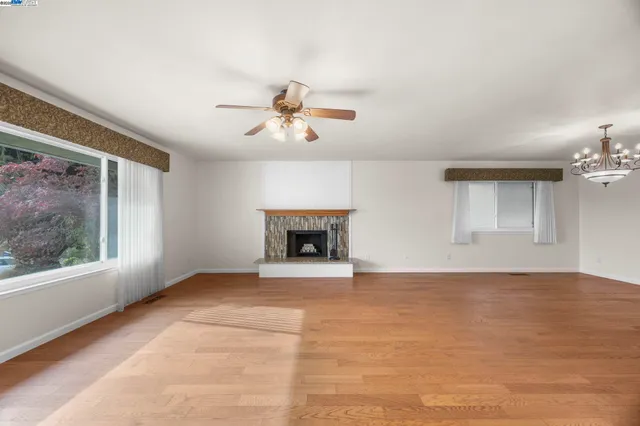 a view of an empty room with a fireplace