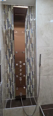 an empty room with a window and a ceiling fan