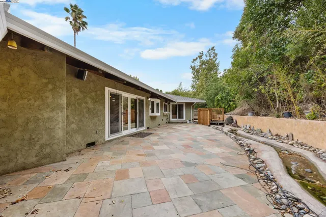 an aerial view of a house with a yard and a large tree