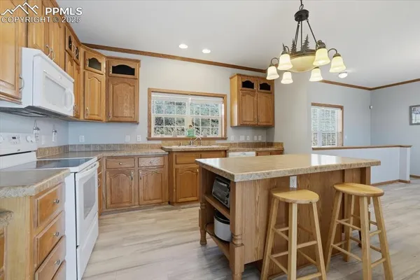 a kitchen with a stove a sink and a refrigerator