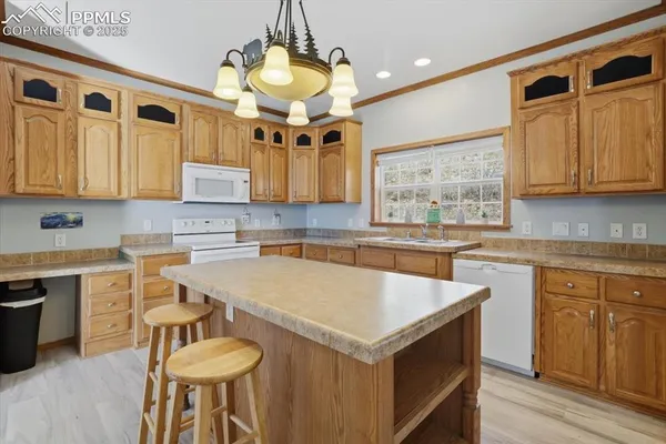 a view of a kitchen with a sink and dishwasher cabinet with wooden floor