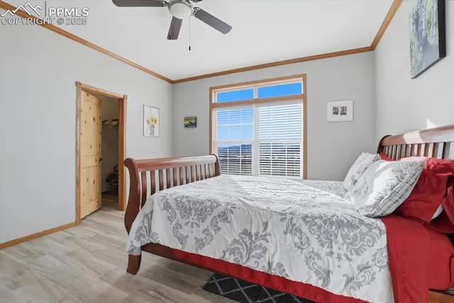 a spacious bedroom with a bed and a chandelier