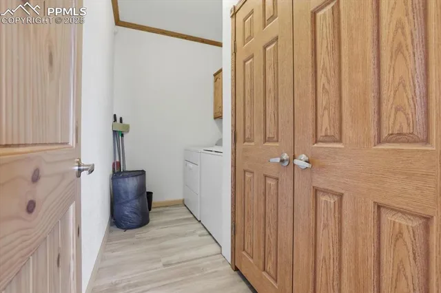 a view of a hallway with wooden floor and a living room