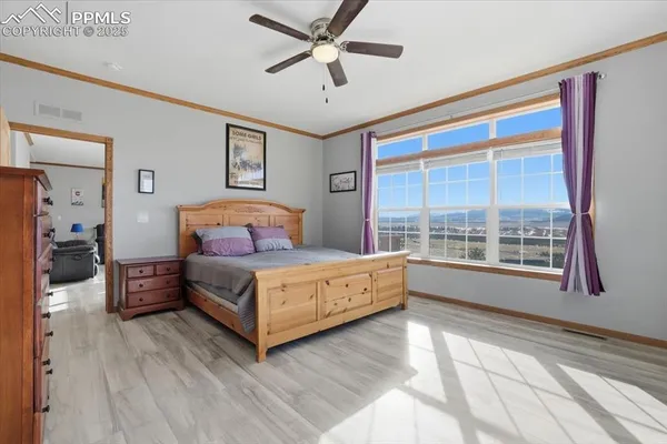 a bedroom with a bed and a large window