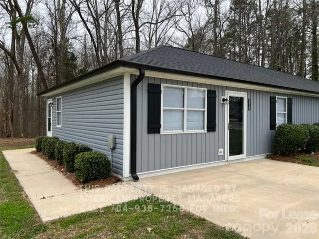 a backyard of a house with plants and trees