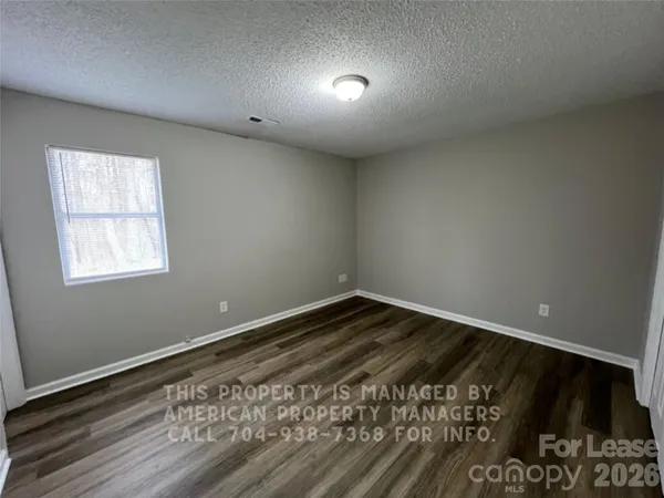 a view of an empty room and wooden floor
