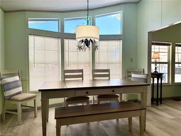 a dining room with table chairs and wooden floor