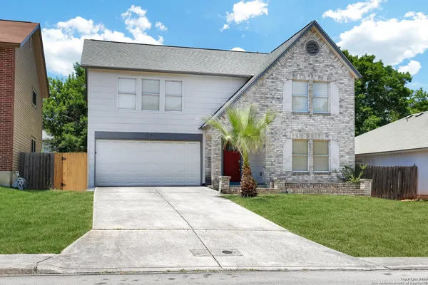 a front view of a house with a yard and garage