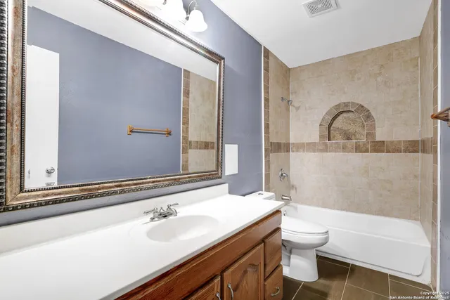 a view of a livingroom with a ceiling fan and window