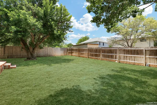 a view of a house with a backyard