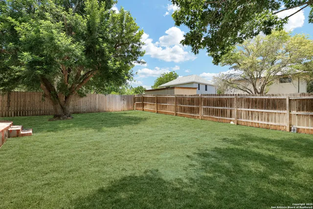 a view of a house with a backyard