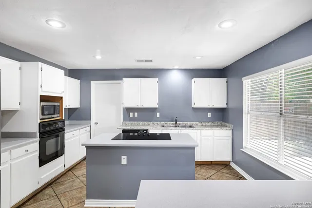 a kitchen with stainless steel appliances a refrigerator stove microwave and sink