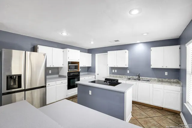 a kitchen with a stove a sink and a microwave