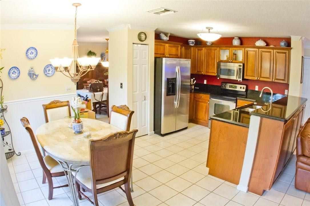 4055 Sabal Lakes Road Delray Beach, FL 33445 - Photo 4 of 13 a dining room with furniture and a floor to ceiling window