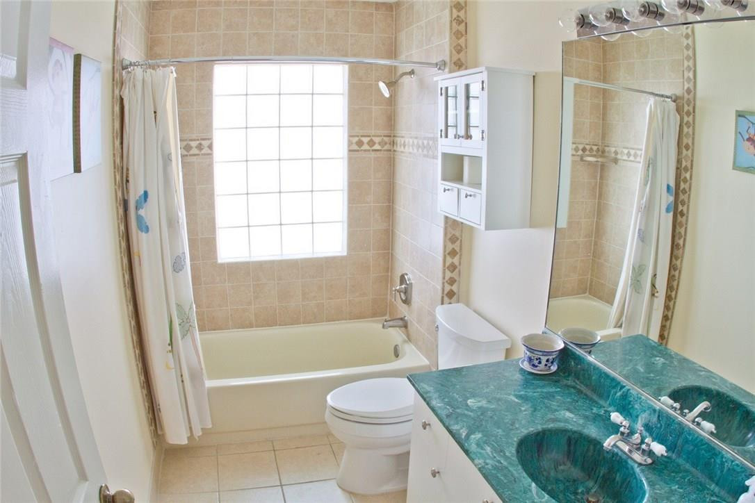 4055 Sabal Lakes Road Delray Beach, FL 33445 - Photo 7 of 13 a bathroom with a sink toilet and shower