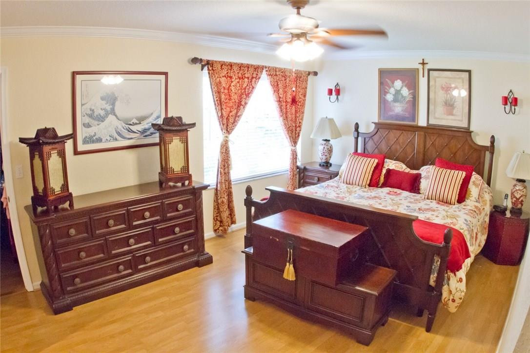 4055 Sabal Lakes Road Delray Beach, FL 33445 - Photo 8 of 13 a bedroom with a bed and wooden floor
