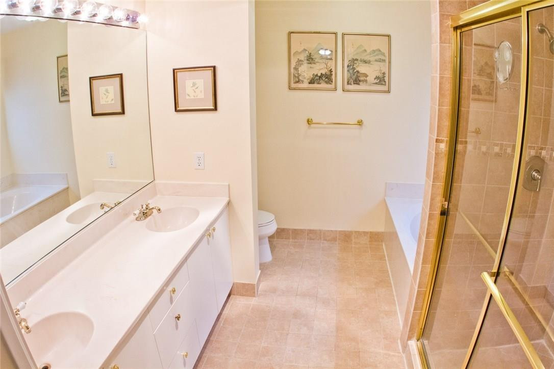 4055 Sabal Lakes Road Delray Beach, FL 33445 - Photo 9 of 13 a bathroom with a sink and a large mirror