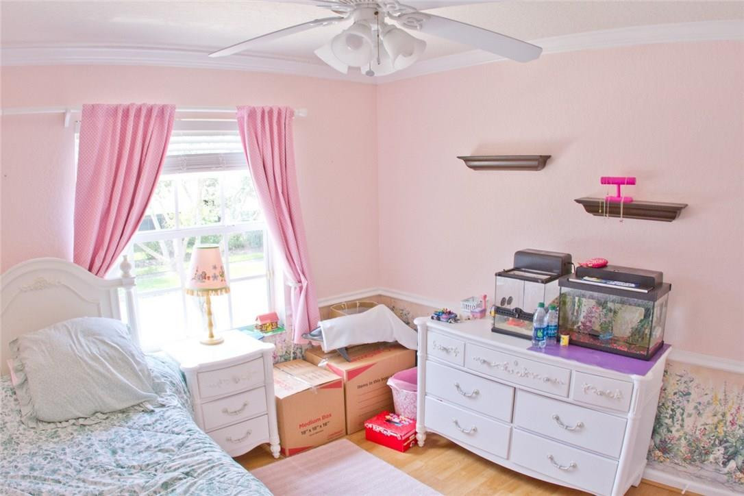4055 Sabal Lakes Road Delray Beach, FL 33445 - Photo 10 of 13 a bedroom with furniture and a window