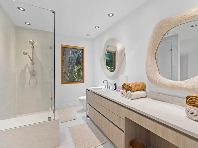a bathroom with a double vanity sink mirror and bathtub