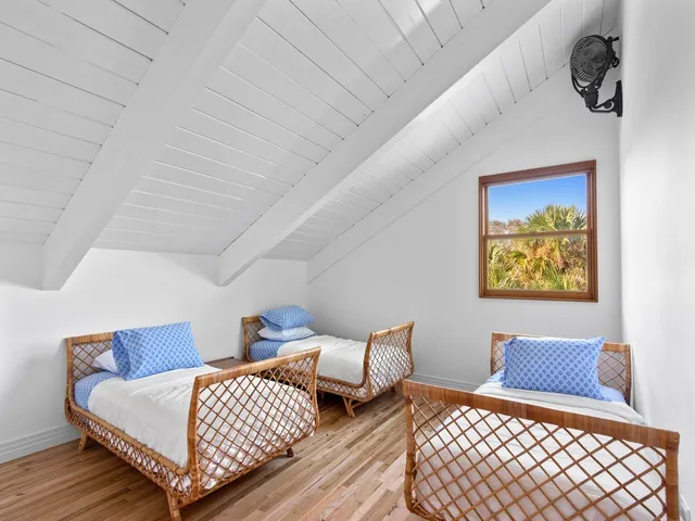 a bedroom with furniture and wooden floor