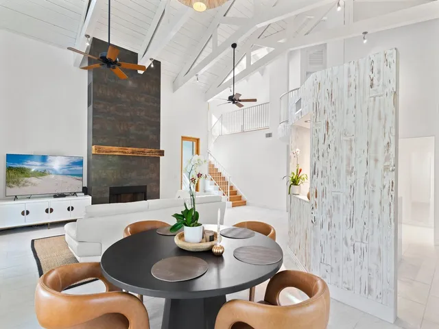 a dining room with furniture and wooden floor