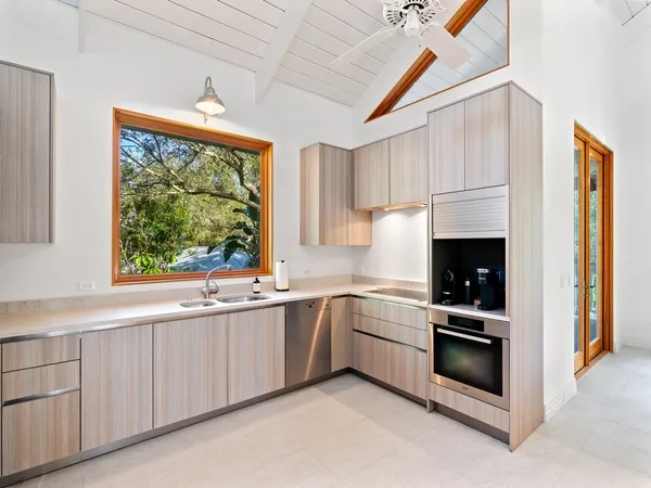 a kitchen with stainless steel appliances white cabinets and a sink