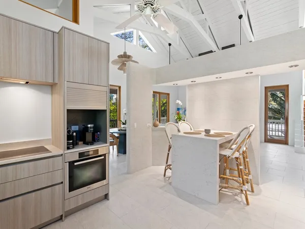 a kitchen with a table chairs stainless steel appliances and cabinets