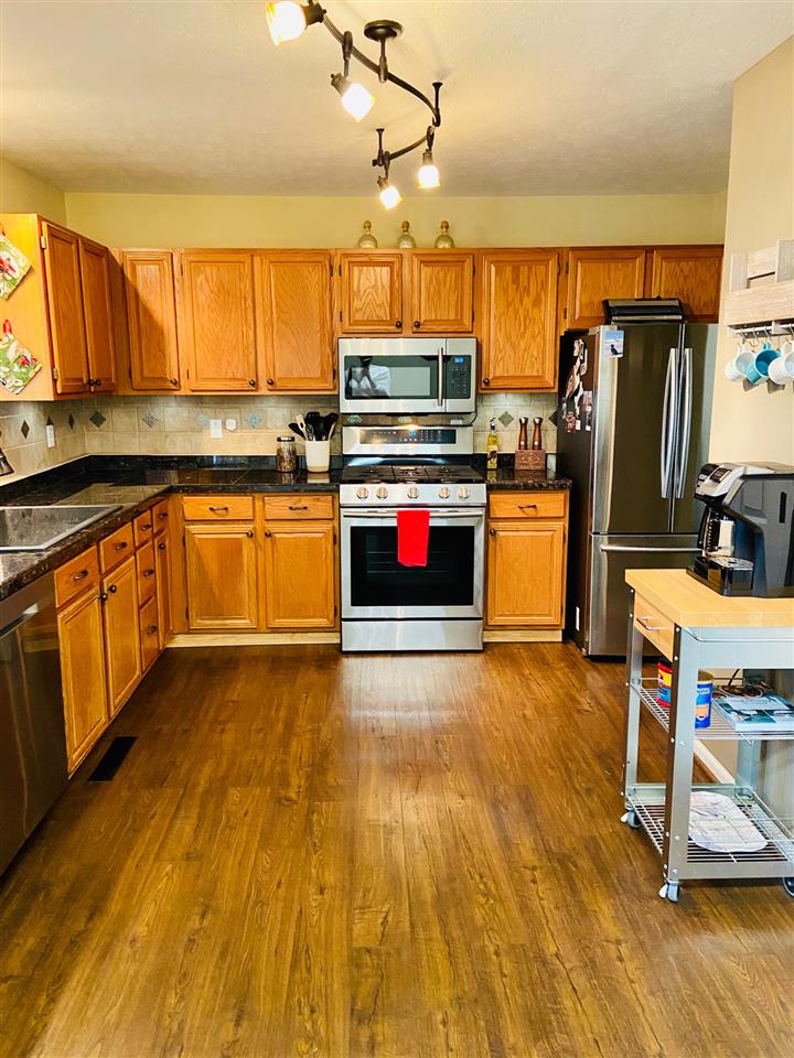 2905 Barterbrook Road Staunton, VA 24401 - Photo 5 of 33 a kitchen with stainless steel appliances wooden floors and wooden cabinets