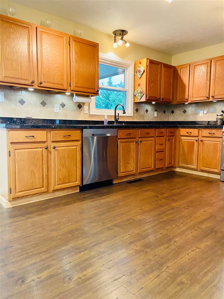 2905 Barterbrook Road Staunton, VA 24401 - Photo 6 of 33 a kitchen with granite countertop a sink cabinets and wooden floor