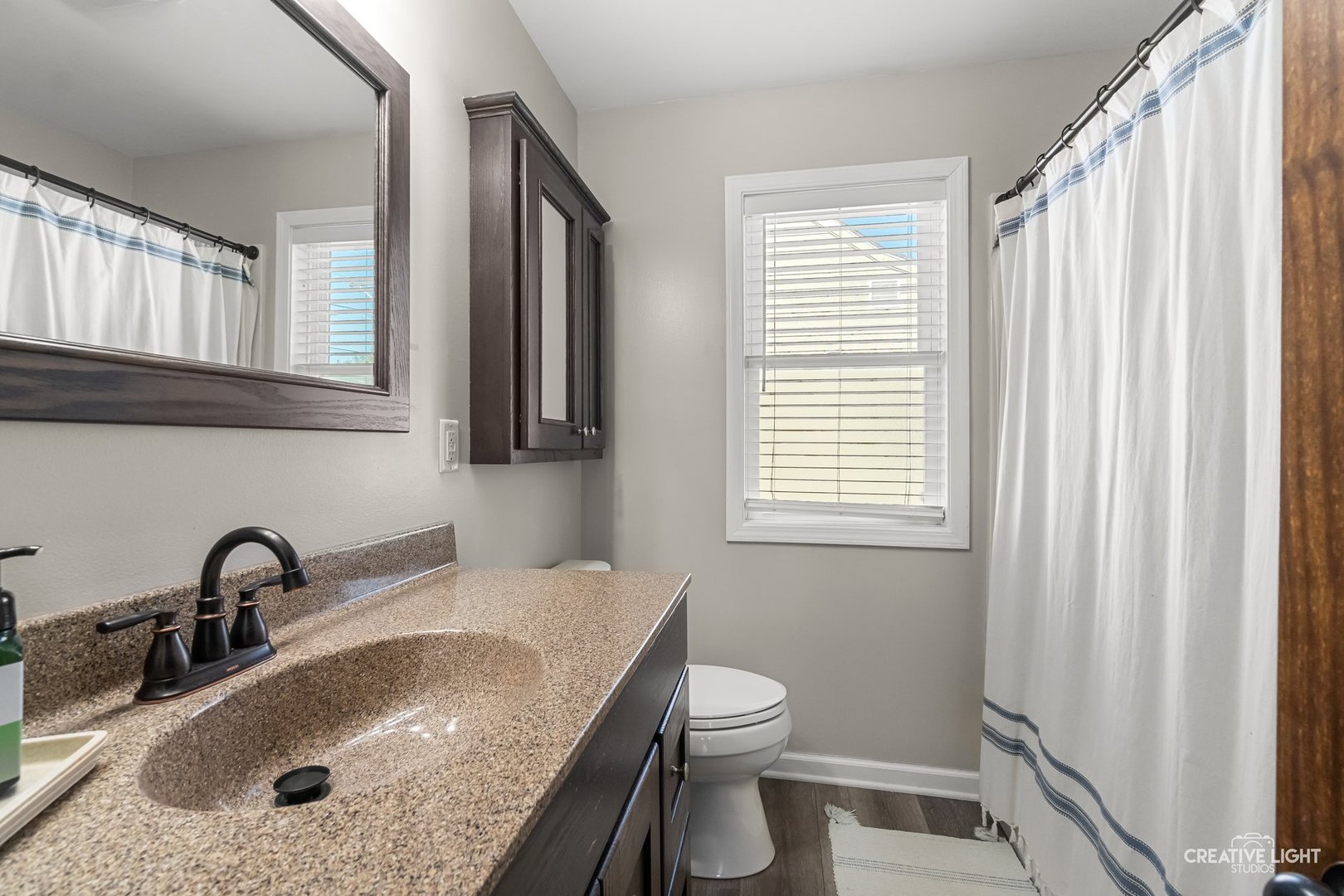 1606 Clark Street DeKalb, IL 60115 - Photo 10 of 20 a bathroom with a granite countertop sink and a toilet