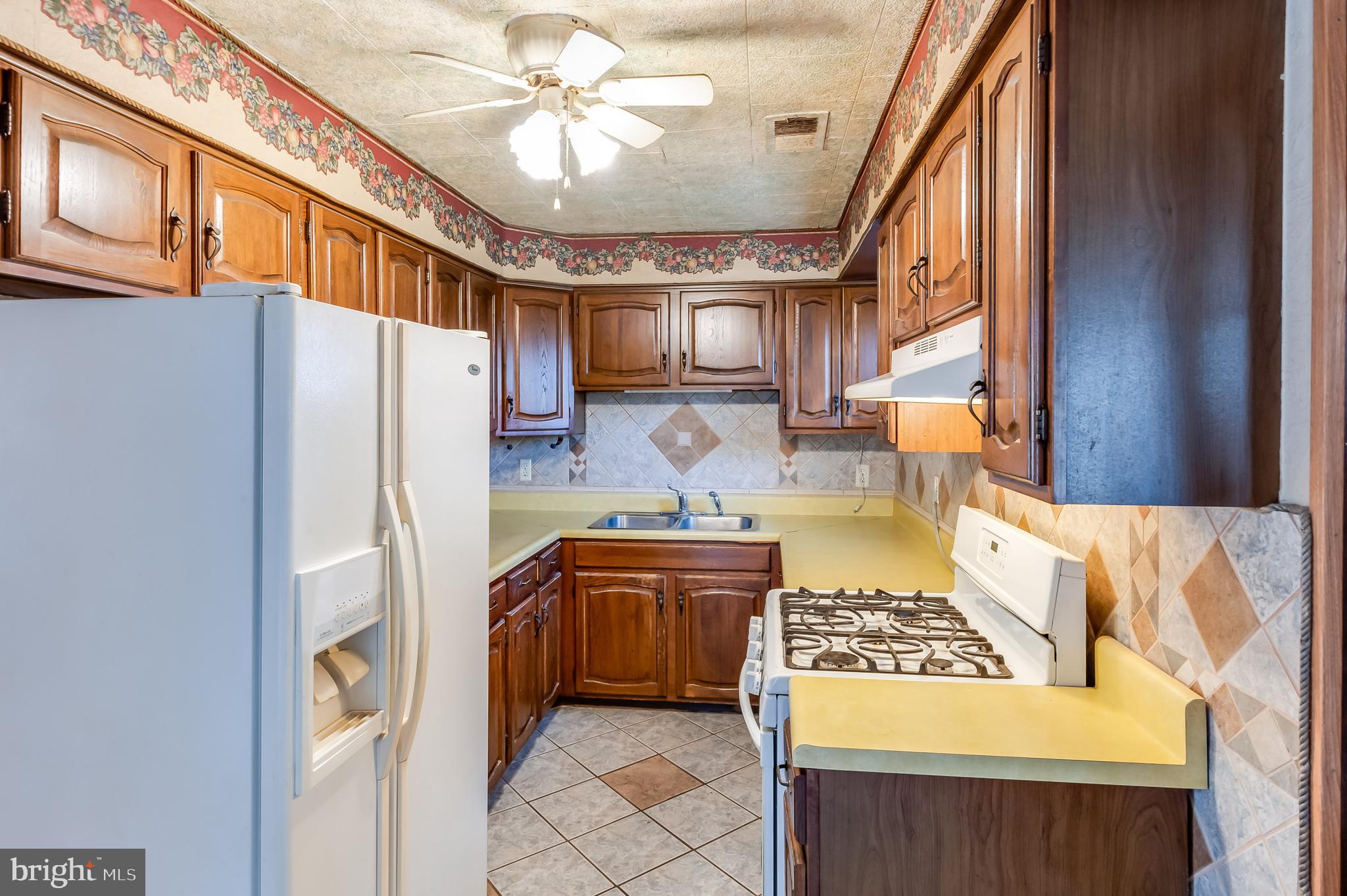 13 Stagecoach Road Southampton, NJ 08088 - Photo 15 of 42 a kitchen with stainless steel appliances granite countertop a sink stove and refrigerator