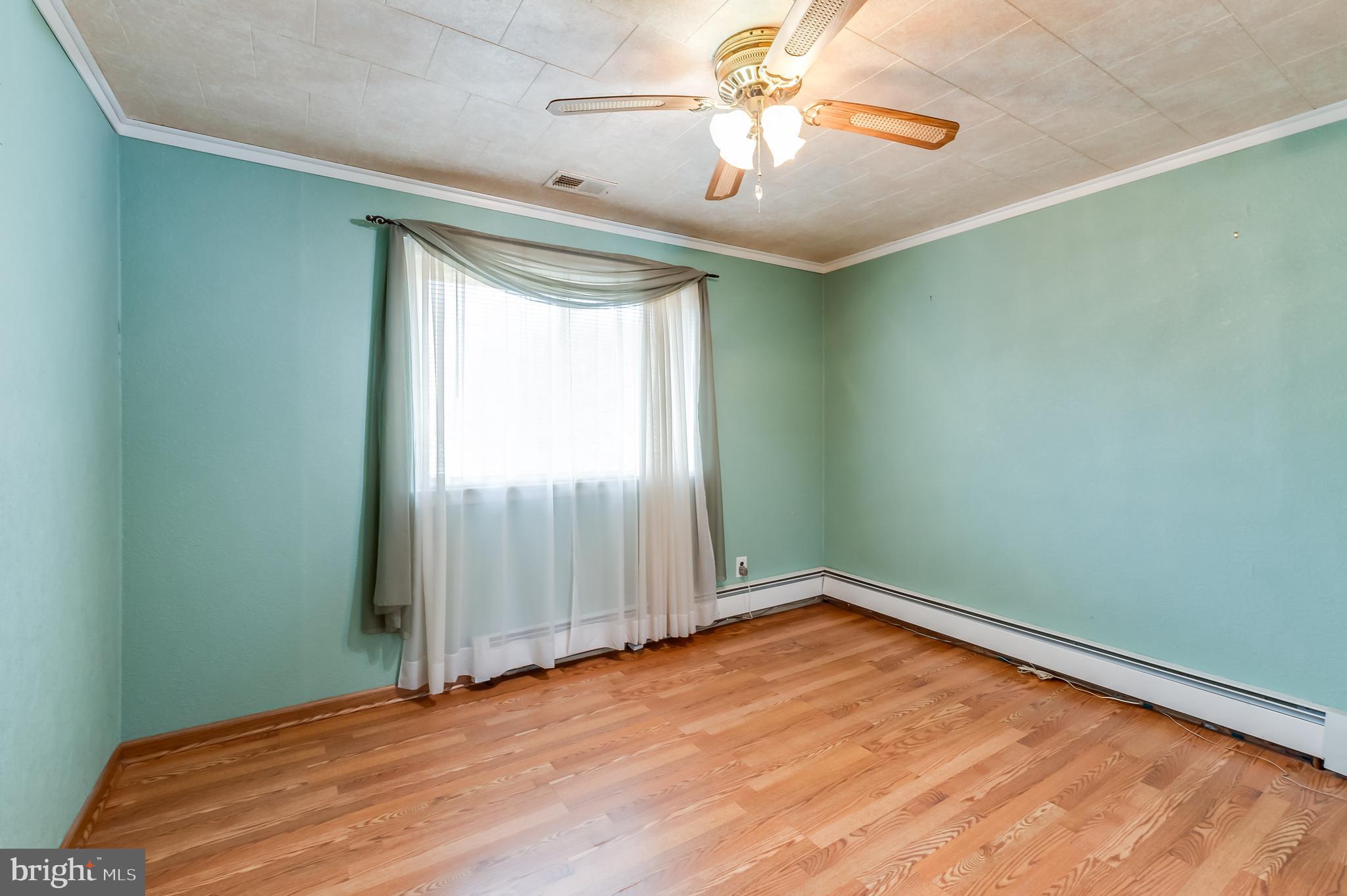 13 Stagecoach Road Southampton, NJ 08088 - Photo 17 of 42 an empty room with a chandelier fan and windows