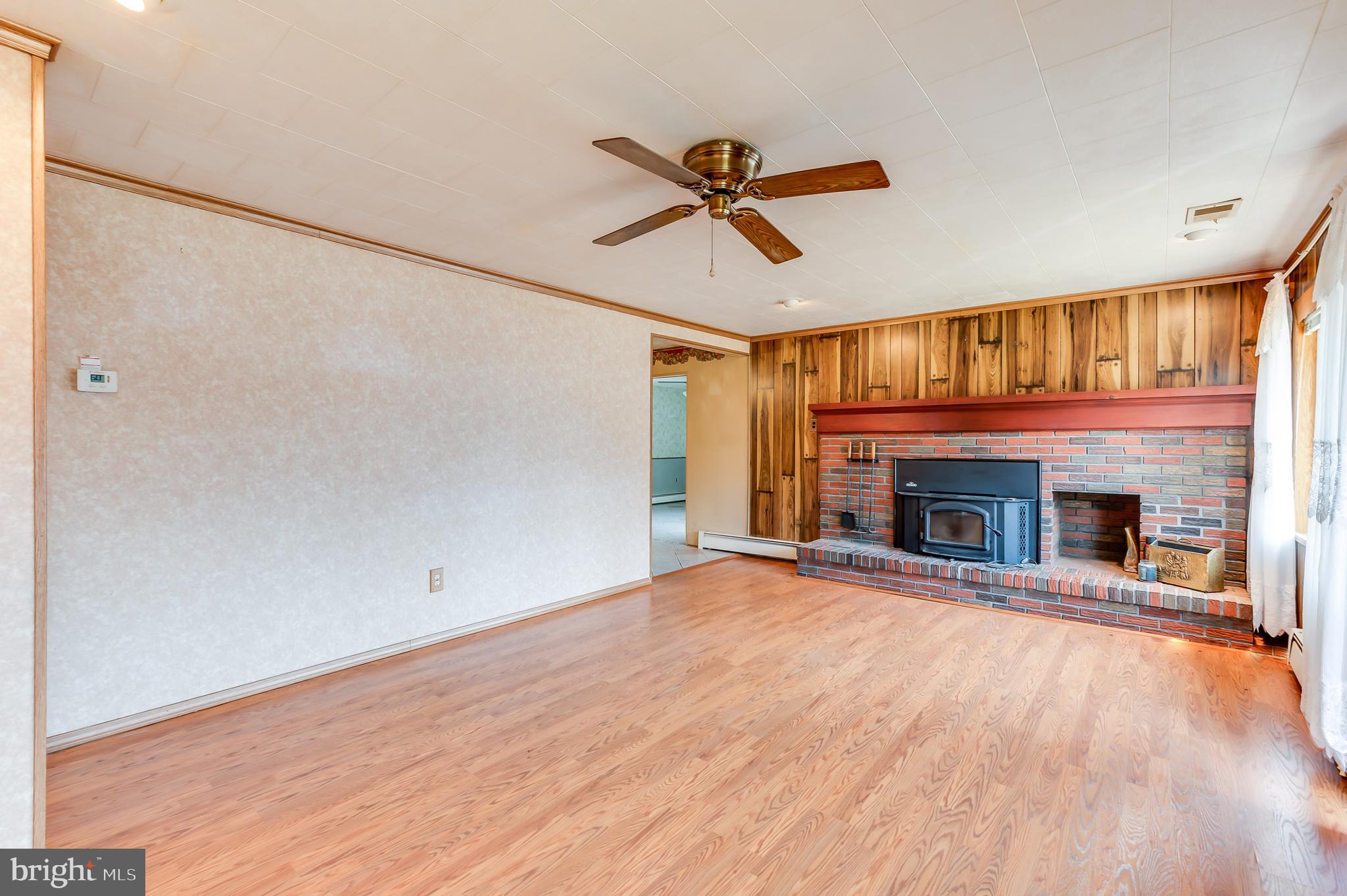 13 Stagecoach Road Southampton, NJ 08088 - Photo 7 of 42 a view of a livingroom with a fireplace a ceiling fan and fire place