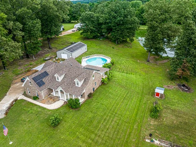 a bedroom with a bed and a flat tv screen on dresser