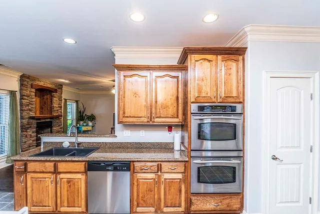 a kitchen with stainless steel appliances granite countertop a stove and a sink