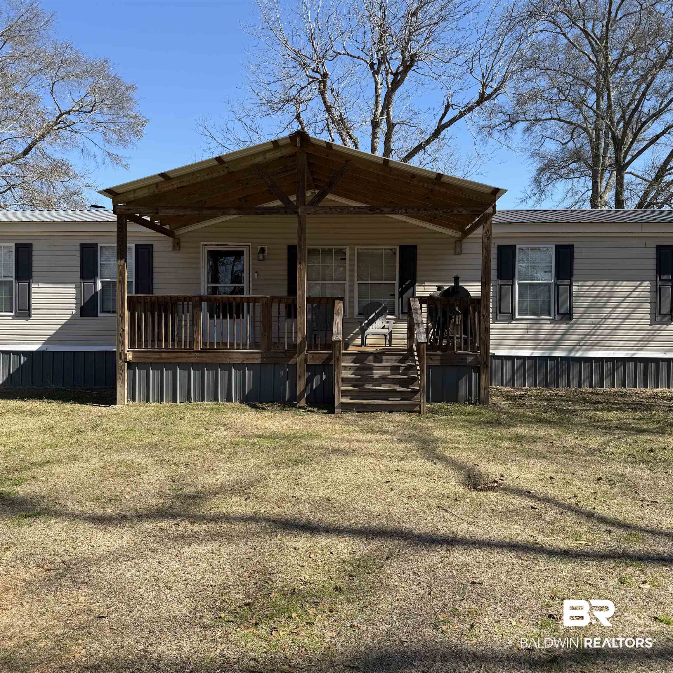 447 Sugar Hill Road Monroeville, AL 36460 - Photo 23 of 27 View of front of property with a metal roof and a front lawn