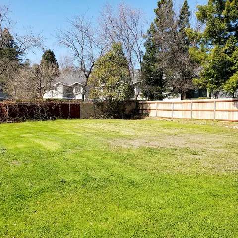 a view of swimming pool with an outdoor seating and a forest
