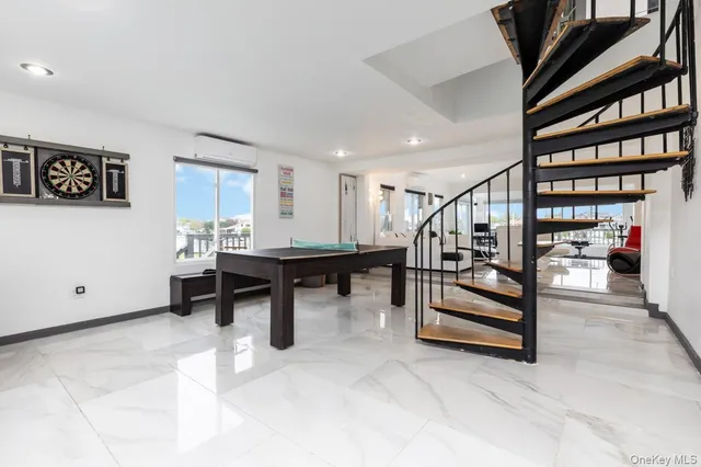 a view of game room with furniture and stairs