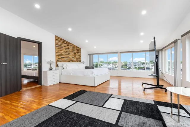 a living room with a flat screen tv and a large window