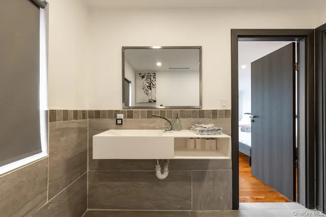 a bathroom with a sink and mirror